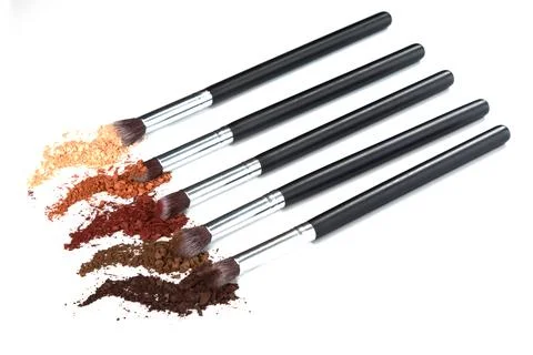 Crushed eyeshadows and make-up brushes Stock Photos