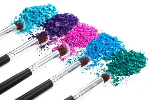 Crushed eyeshadows and make-up brushes Stock Photos