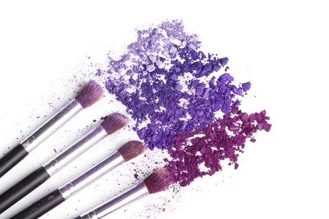 Crushed eyeshadows and make-up brushes Stock Photos