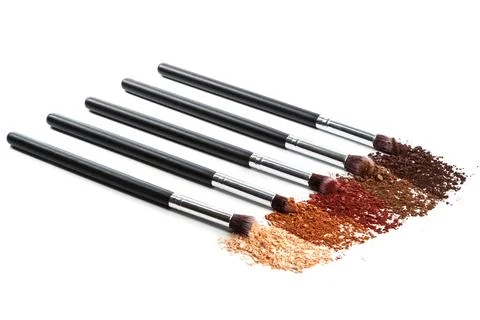 Crushed eyeshadows and make-up brushes Stock Photos
