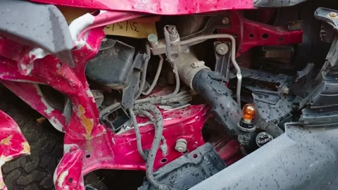 Crushed front section of damaged car with exposed wiring and structural Stock Footage 345716726