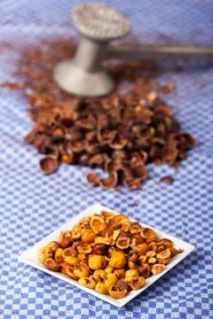 Crushed hazelnuts with nutshells on a dish towel Stock Photos