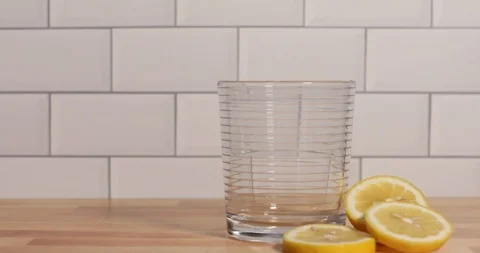 Crushed ice being placed in glass then beverage poured into glass Stock Footage 125785000