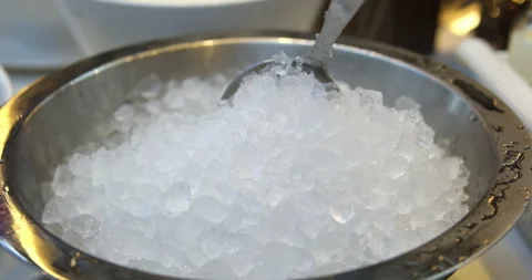 Crushed ice for drinks Use a large ladle to scoop ice for drinks from an iron Stock Footage 276574032