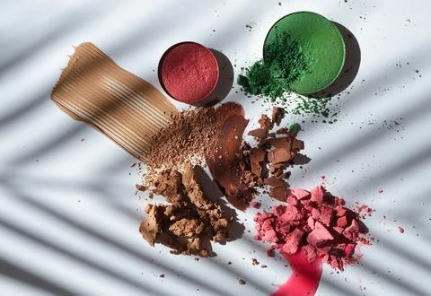 Crushed Makeup Products with Dramatic Palm Shadow on White Background  Beauty Stock Photos