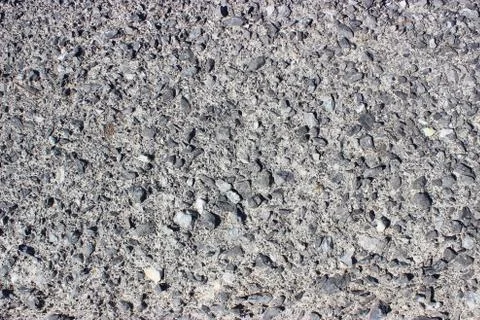 Crushed old asphalt pavement. Small gray-black pebbles. Stock Photos