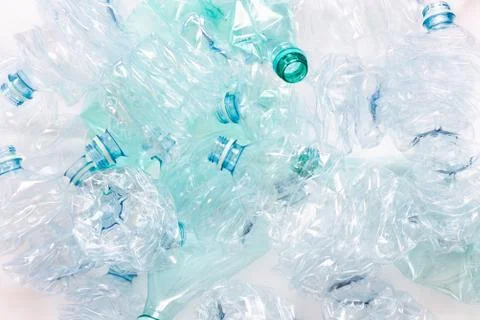 Crushed plastic bottles background - light Stock Photos