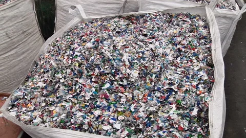 Crushed plastic bottles in the bag prepared for recycling Stock Footage 85555908