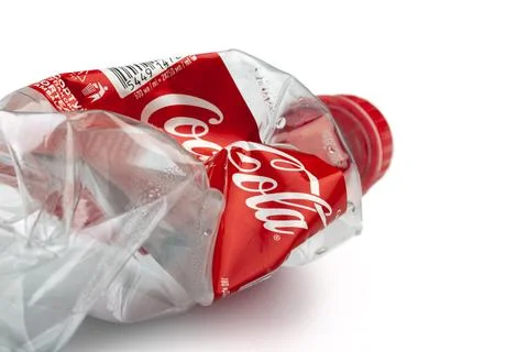 Crushed plastic Coca-Cola bottle for recycling Stock Photos