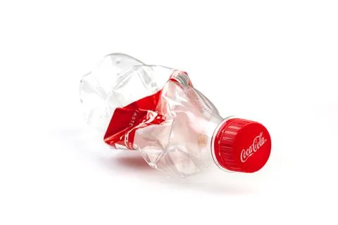 Crushed plastic Coca-Cola bottle promoting recycling concept Stock Photos
