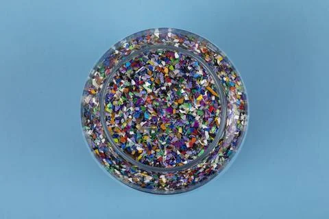Crushed plastic pellets particles made of multicolored recyled plastics Stockfoto's