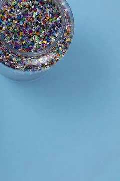 Crushed plastic pellets, particles made of multicolored recycled plastic 스톡 사진