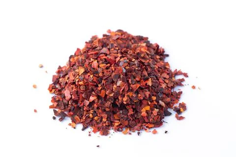 Crushed red chilli pepper cayenne flakes isolated on white background Stock Photos