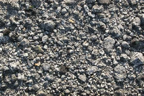 Crushed stone background. Small rocks on a mountain trail Stock Photos