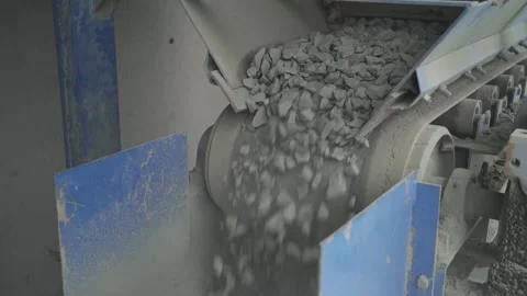 Crushed stone is dumped from a conveyor onto a moving belt. running belt Video stock 145410994