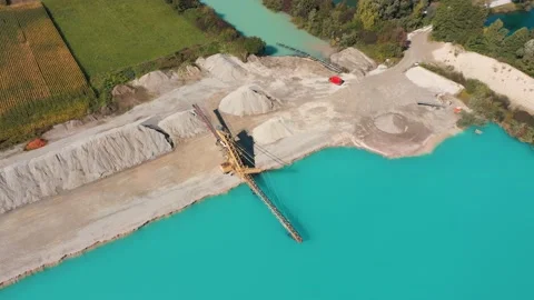 Crushed stone mining machine. Turquoise water quarry. Stock Footage 231228973