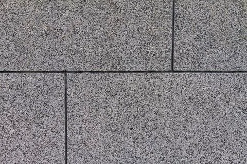 The crushed stone surface of the wall, separated by squares. Stock Photos