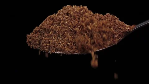 Crushed turmeric falling from the iron spoon, black background studio, slow Vidéo 74726232