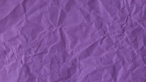Crushed Violet Wrapping Tissue Ball Showing Deep Folds On Dark Canvas 動画素材 346907724