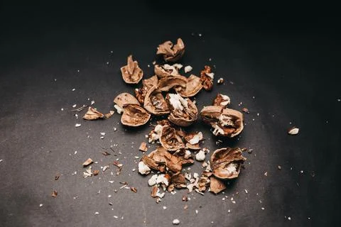 Crushed walnuts on black background. Foto stock