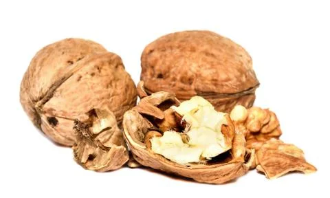 Crushed walnuts with nutshell isolated on white background Stock Photos