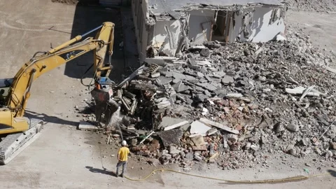 Crusher at work  while a worker uses a water jet to prevent dust   1 Stock Footage 196123138