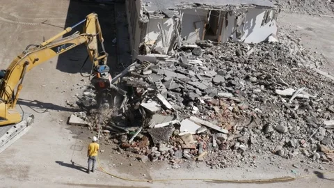 Crusher at work  while a worker uses a water jet to prevent dust 2 Stock-Footage 196125058