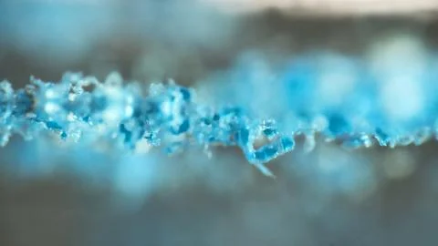 Crushing and agglomeration of plastic particles on water surface. Stock Photos