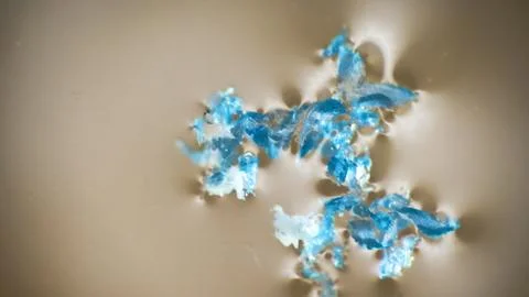 Crushing and agglomeration of plastic particles on water surface. Stock Photos
