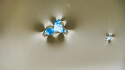 Crushing and agglomeration of plastic particles on water surface. Stock Photos