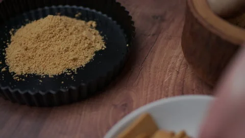 Crushing and grinding biscuits in a wooden mortar with a pestle into a powder. Stock Footage 138081853