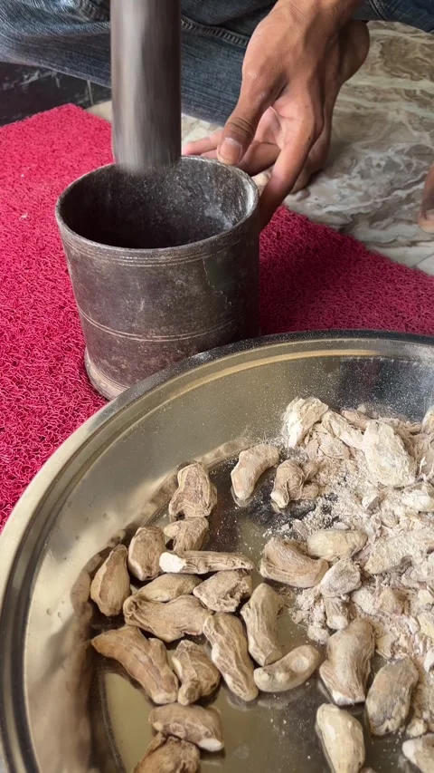 Crushing Dried Ginger Roots with Mortar and Pestle Video stock 331987548