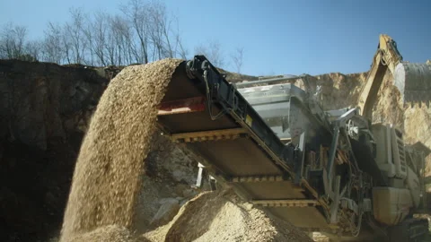 Crushing machine and excavator at work in quarry, rocks production for road base Video stock 293965955