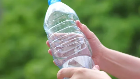 Crushing the plastic bottle with hands in 4k slow motion 60fps Stock Footage 155726828