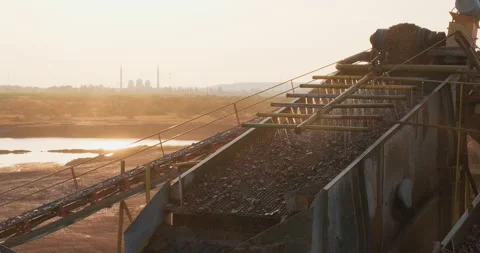 Crushing screening plant. Rocks and sand move up on conveyor line to vibrating Stock Footage 288735338