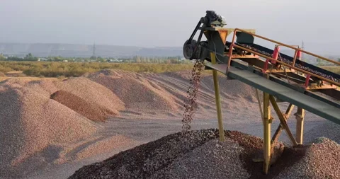 Crushing screening plant. Sorted rocks move on conveyor line, fall into a pile Stock Footage 288738456