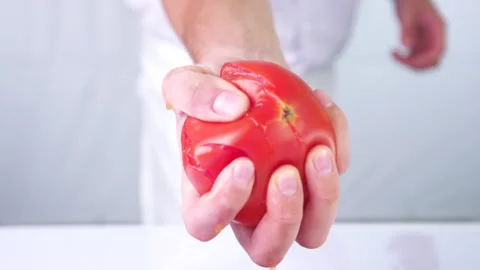 Crushing tomato hand. Stock Footage 141561437