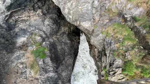 Crushing waves in the cliffs - gap in the rocks Stock Footage 239234047