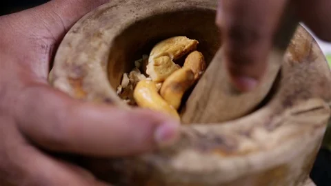 Crushing Whole Cashews Stock-Footage 122851802