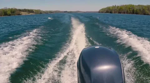 Crusing motorboat making a wake Stock Footage 63875564