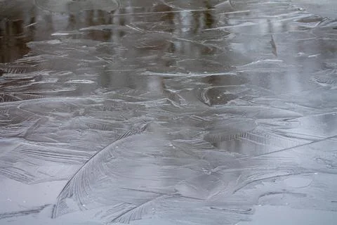 Crust of ice with a pattern on the lake Stock Photos