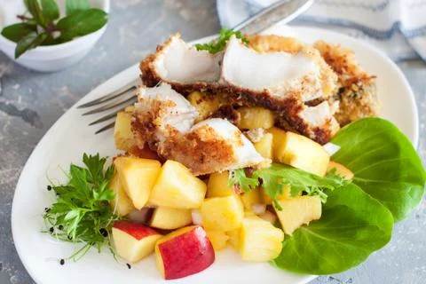 Crusted cod with peach and pineapple salsa Stock Photos
