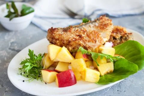 Crusted cod with peach and pineapple salsa Stock Photos