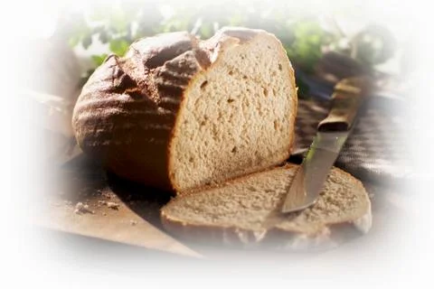 Crusty bread, partly sliced Stock Photos