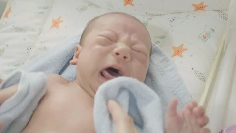 Crying Baby with Blanket in Soft Setting Stock Footage 318629290