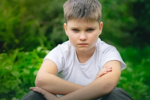 Crying boy in tears looking to camera. lonely scared child bullying at school Stock Photos