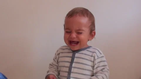 Crying child against white wall Stock Footage 47140429