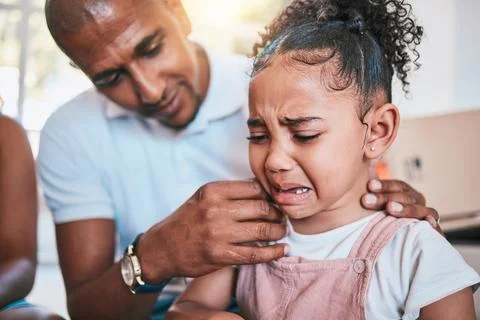 Crying, child and dad support with love and parent care in a family home with a Stock Photos