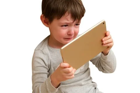 Crying child looking at digital tablet screen isolated on white background. F Stock Photos