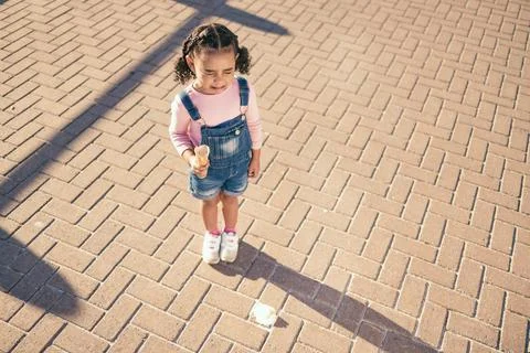 Crying kid drop ice cream on floor, ground and street in summer, sunshine and Stock Photos